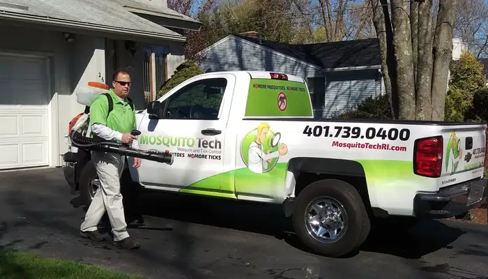 Mosquito Tech technician applying treatment in Rhode Island