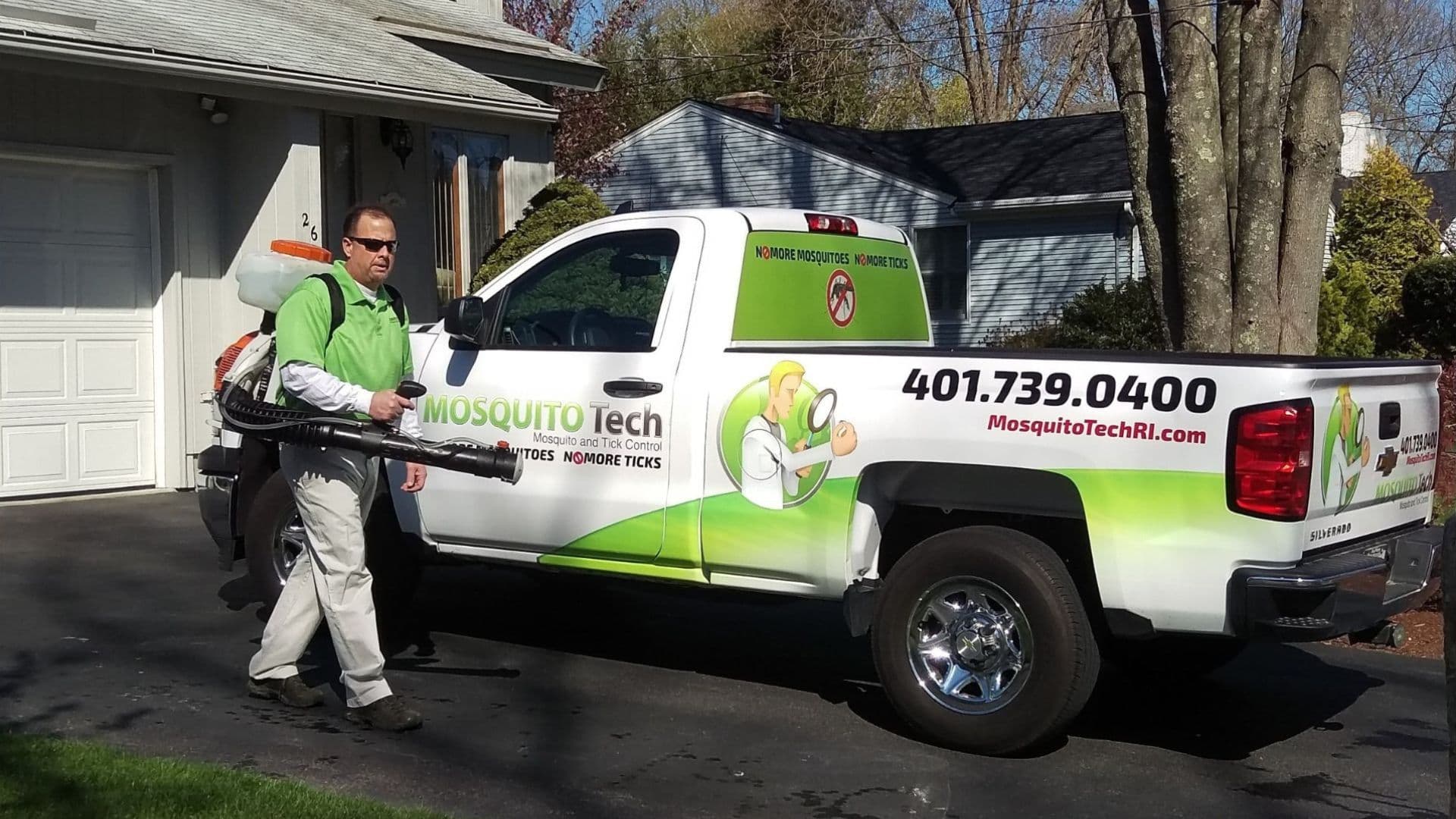 Mosquito Tech technician applying treatment in Rhode Island